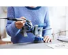 A person is using a Dremel rotary tool to engrave or polish an object held in a vise. Anteprima dell’immagine prodotto
