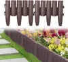 A garden border made of brown plastic elements with a wood-like texture is installed along a flower bed and a pathway. Produktbild-Vorschau