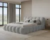 A modern bedroom with a large bed, large windows with curtains, and a wooden accent wall. Voir les images du produit