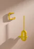 A yellow toilet brush set and toilet paper holder mounted on a light pink wall. Anteprima dell’immagine prodotto
