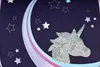 A close-up of a dark blue fabric with a unicorn design and stars. Produktbild-Vorschau