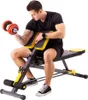 A man is sitting on a weight bench and lifting a dumbbell. Produktbild-Vorschau