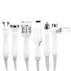 A collection of white cosmetic treatment devices with silver accents, arranged horizontally against a white background. Produktbild-Vorschau