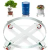 A product shot featuring a metal drum dolly with a bonsai tree, a blue barrel, and a trash can on dollies in the background. Náhľad obrázku produktu