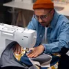 A person is sewing on a Brother sewing machine. Produktbild-Vorschau