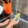 A person washing a glass in a sink. Anteprima dell’immagine prodotto