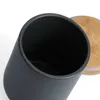 Close-up view of the top opening of a dark gray ceramic storage jar with a bamboo lid partially visible. Produktbild-Vorschau