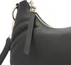 A close-up view of a black leather handbag. Voir les images du produit
