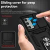 A hand is holding a black phone case with a sliding camera cover and a ring holder. The image highlights the features of the case. Produktbild-Vorschau