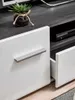 Close-up of a modern TV stand with drawers and a small plant. Produktbild-Vorschau