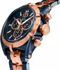 A close-up, angled view of a blue and rose gold analog watch against a white background. Anteprima dell’immagine prodotto