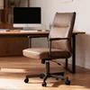 A brown office chair is shown in front of a desk with a computer. Náhľad obrázku produktu
