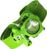 A close-up studio shot of a green alligator-shaped children's watch against a white background. Voir les images du produit