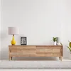 A digital weather station is displayed on a wooden cabinet next to a lamp and plants. Produktbild-Vorschau
