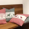 Cushions with deer embroidery on a wooden bench. Produktbild-Vorschau