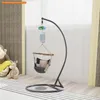 A baby swing stand with a hammock and pillows, set up in a room with toys. Produktbild-Vorschau