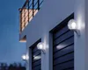 Outdoor wall lights mounted on a building at dusk. Anteprima dell’immagine prodotto