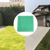 A collage showing a green manhole cover in the center, with a house and driveway on the right, and a building with a tiled roof and greenery on the left. Podgląd zdjęcia produktu