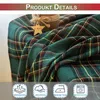 A close-up of a green plaid fabric, likely a curtain or blanket, with a decorative element and icons at the bottom. Podgląd zdjęcia produktu