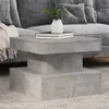 A modern living room setting with a gray couch and a concrete-style coffee table. Produktbild-Vorschau