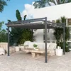 An outdoor living space with a pergola, seating, and a coffee table. Produktbild-Vorschau