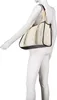 A mannequin wearing a white long-sleeved shirt and white pants is modeling a beige and black tote bag. Anteprima dell’immagine prodotto