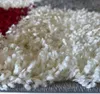 A close-up view of a shaggy rug with a geometric pattern. Produktbild-Vorschau