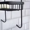 A close-up shot of a black metal shower caddy with a bar of soap. Náhled obrázku produktu
