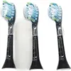 Three black toothbrush heads with blue, green, and white bristles are arranged in a row against a white background. Produktbild-Vorschau