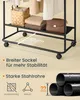 A close-up view of a black rolling garment rack with various items on its shelves, along with descriptive text and diagrams highlighting its features. Produktbild-Vorschau