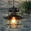 A vintage-style pendant light hangs in front of a stone wall with some greenery in the background. Produktbild-Vorschau