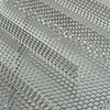 A close-up, angled view of a perforated metal grilling accessory. Produktbild-Vorschau