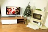 A living room decorated for Christmas, featuring a TV, a fireplace, and a Christmas tree. Podgląd zdjęcia produktu