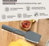 A close-up of a gray spatula on a wooden cutting board with a fig and cheese. Produktbild-Vorschau
