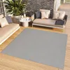 An outdoor patio setting with furniture and a rug. Náhled obrázku produktu