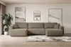 A spacious living room with a large sectional sofa, artwork, and a potted plant.