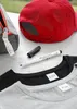A close-up shot of clothing and accessories with names written on them, suggesting personalization or team identification. Produktbild-Vorschau