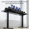 A black standing desk with weights on top, in front of a window with blinds. Anteprima dell’immagine prodotto