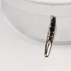 A close-up of a silver metallic object attached to a white object. Náhled obrázku produktu