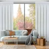 A living room scene with a sofa, coffee table, and curtains. Produktbild-Vorschau