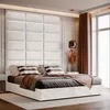 A bedroom scene with a bed and upholstered headboard. Anteprima dell’immagine prodotto