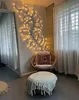 A cozy corner with a chair, ottoman, and decorative lights. Produktbild-Vorschau