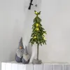 A decorative Christmas tree with lights and two gnomes on a shelf. Produktbild-Vorschau