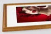 A framed picture of a woman with red roses. Produktbild-Vorschau