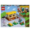 The image shows the packaging of a LEGO Minecraft horse stable playset. The packaging displays the product in a 3D cutaway view, along with individual components and minifigures. Podgląd zdjęcia produktu