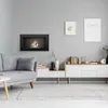 A modern living room with a grey sofa, a black bioethanol fireplace, and a white media console. Náhled obrázku produktu