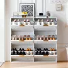 A white shoe cabinet with multiple shelves and doors, filled with shoes, is shown in a room with white walls and wooden flooring. Anteprima dell’immagine prodotto