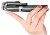 A hand holding a black selfie stick with a phone attached. Náhled obrázku produktu
