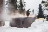 People relaxing in a hot tub outdoors in the snow. Náhled obrázku produktu