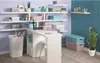 A home office or craft room setting with shelves filled with storage boxes, a desk, and a plant. Náhľad obrázku produktu